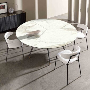 Distinguished Sovet Italia Arkos XXL table with light faux marble top and dark metal legs featuring gold accents