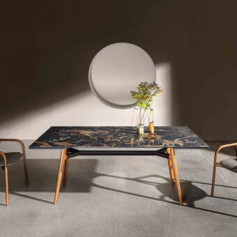 Extendable table, black marble with gold veining, angled light wood legs, metal band, Sovet Italia lewood, modern dining setting.