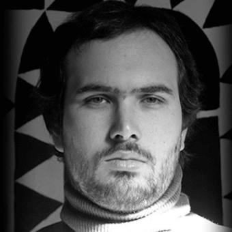 Neutral portrait of Jonas Clementoni with dark hair, wearing a ribbed turtleneck, set against a black and white geometric triangle pattern backdrop.