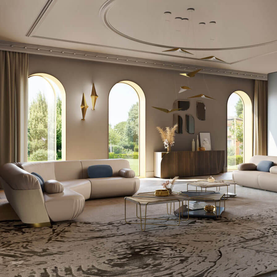 Living room interior with beige sofa, taupe walls, arched windows, and a patterned rug featuring gold sculptures and blue pillows.