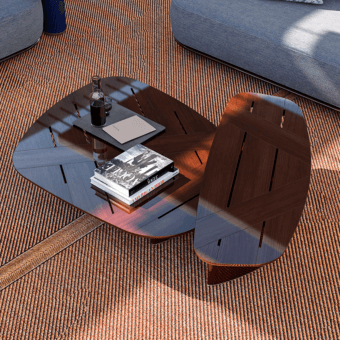 Coffee table, reddish-brown wood, leaf-shaped with segmented lines, styled with books, ottoman, pillow, and glass bottle on orange rug.