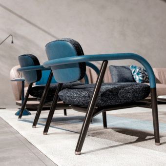 Distinguished CPRN Homood Maiori lounge chair with elegant blue fabric and brown padded leather armrests, built with a sleek matte metal frame