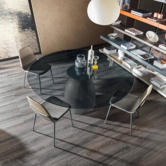 Distinguished Lago Janeiro table with transparent glass top and textured anthracite finished concrete base