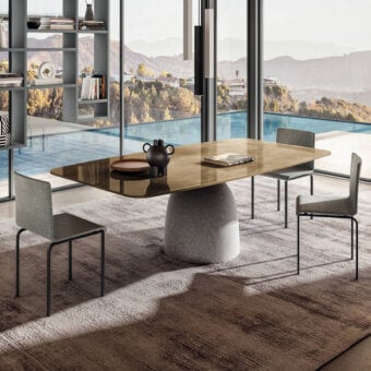 Distinguished Lago Janeiro table with brownish glass top and natural anthracite textured concrete base