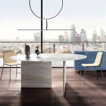 Innovative Lago Stratum table with round XGlass top mimicking marble swirls and stratified glass leg allowing light filtration