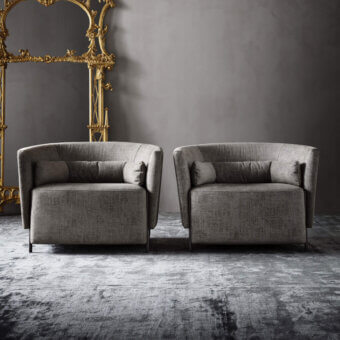Exclusive OAK Melodia lounge chair upholstered in textured matte gray fabric with elegant dark metal feet and detachable lumbar support