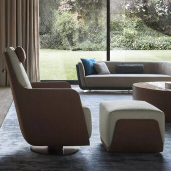 Exceptional OAK New York lounge chair upholstered in warm brown textile with cream interior and matte wood-like swivel base