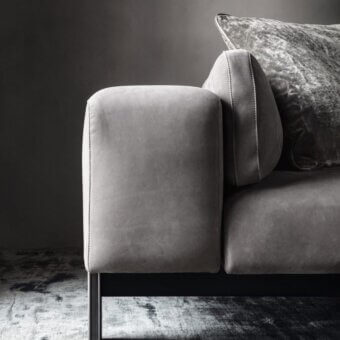 Elegant OAK Opera sofa with smooth grey textile upholstery and dark toned metal legs and carter