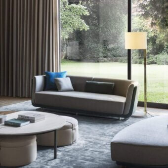 Distinguished OAK Solomon sofa with architectural curves upholstered in light gray textile and dark trim