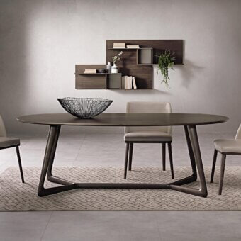 Elegant Pacini & Cappellini Cover table with oval veneered ash wood top and inclined solid ash wood base in dark brown matte finish