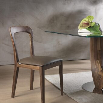 Distinguished Pacini & Cappellini Gaya chair crafted with dark brown leather and a solid Canaletto walnut frame exhibiting balanced geometric forms