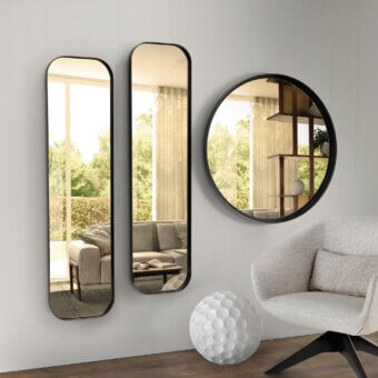Distinguished Pacini & Cappellini Ron mirror with a sleek dark matte metal frame reflecting a curated interior