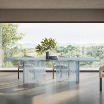Innovative Reflex Laguna table with a light blue-grey glass top and bases crafted with a unique molten texture