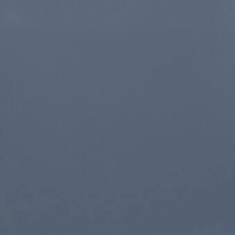 Muted indigo solid color background with a matte finish and smooth texture, displaying subtle tonal variations across a uniform surface.