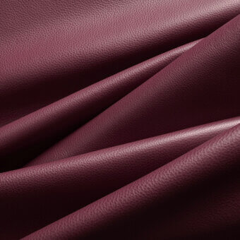 Burgundy leather expanse, pebbled texture, overlapping folds create dynamic shadows, rich wine-red hue, studio lighting, label reads "af 34".
