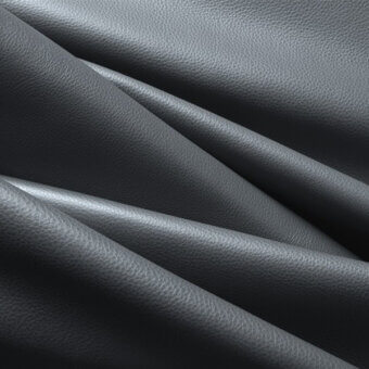 Dark gray leather texture with overlapping folds, exhibiting a pebbled grain and diagonal shadows, studio lit with “af 71” tag.