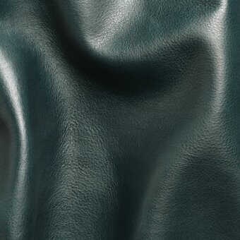Dark teal leather sheet with granular texture, folded in undulating shapes, glossy finish, studio gray background.