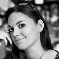 Black and white portrait of Giada Chervatin with dark hair, silver headband, and subtle expression, soft diffused lighting.
