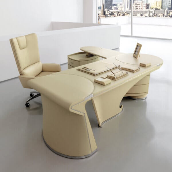 Cassoni Mascheroni executive desk, beige leather upholstery, curved shape with integrated pen trays, paired with circular accent table.