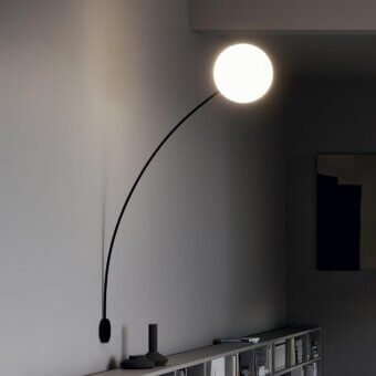 Elegant Italamp Filo wall lamp with white blown glass diffuser and refined black metal structure creating a modern silhouette