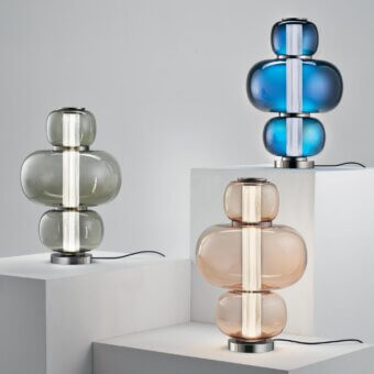 Captivating Italamp Nube lamp with stacked rounded glass sections and iron grey metal accents, built with a hand-carved crystal diffuser