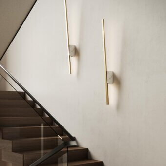 Distinguished Italamp Regolo wall lamp with golden metal and refined marble, emitting warm 3000K LED light through a methacrylate shade