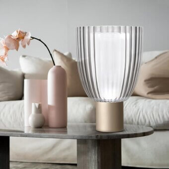 Elegant Italamp Universale table lamp with carved crystal and satin blown glass diffusers resting on a gold-toned metal base