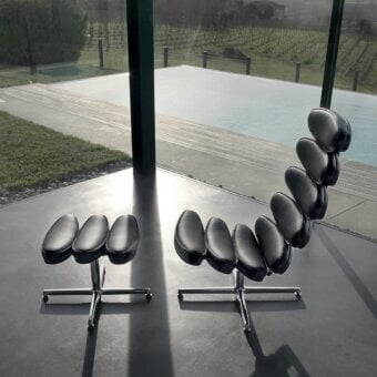 Elegant Mascheroni Airone lounge chair with oval seat and back in smooth natural leather and minimalist metal base