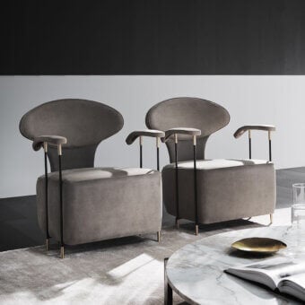 Superior Mascheroni Magicabula lounge chair with rounded geometric forms and muted gray textile upholstery crafted with black steel and precious brass feet