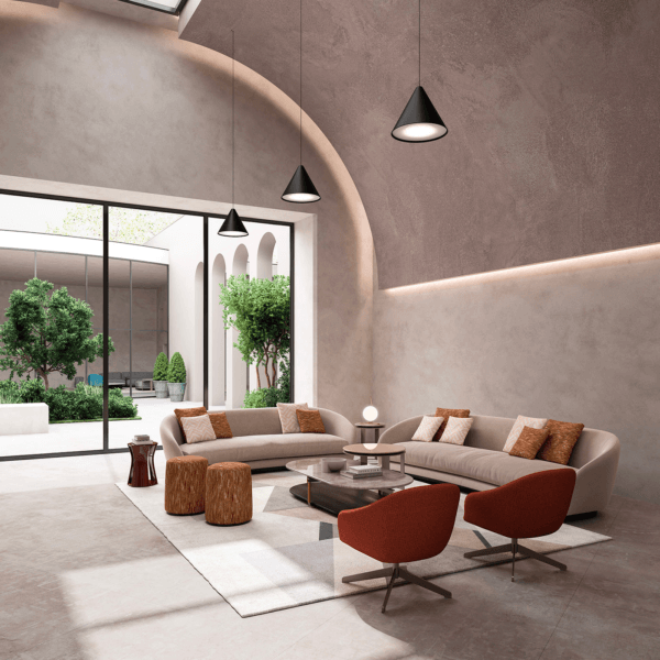 Curved sectional sofa, beige fabric, rust pillows, terracotta armchairs, mirrored coffee table, gray tile floor, modern living room interior.