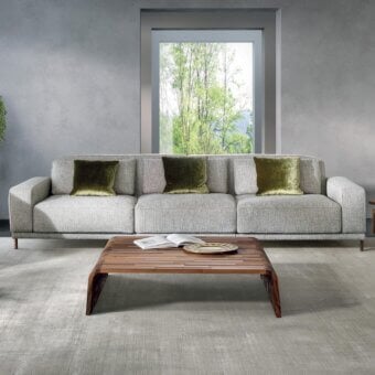 Distinguished Pacini & Cappellini Costanza sofa with light textured fabric upholstery and olive green velvet cushions built on dark wood feet