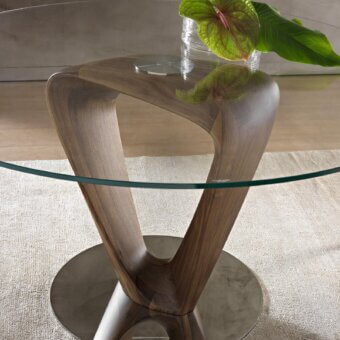 Exceptional Pacini & Cappellini Mobius table with a sinuous wooden base and clear tempered glass top crafted with a glossy finish