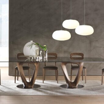 Superior Pacini & Cappellini Mobius table with sleek tempered glass top and sinuous wooden elements mounted on chromed metal plates