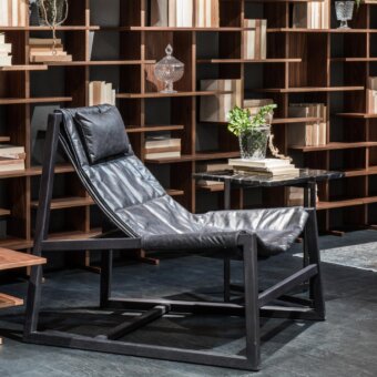 Exceptional Pacini & Cappellini relax lounge chair with matte leather seat and dark finished solid wood structure
