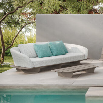 Stylish Reflex Segno sofa in light grey speckled textile with a modern minimalist frame and curved silhouette