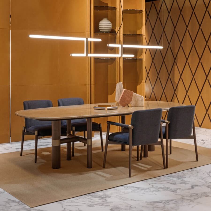 Distinguished Turri Atelier table crafted with walnut wood legs and brass metal inlays, showcasing a light beige stone-look tabletop