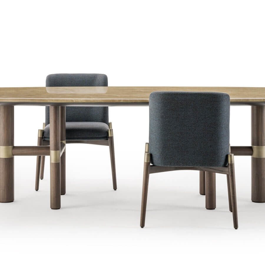 Lavish Turri Atelier table crafted with walnut legs, brass inlays and a light brown elongated tabletop