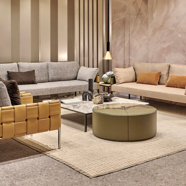 Distinguished Turri Ratio lounge chair with soft gray cushions and woven tan leather exterior with polished metal legs