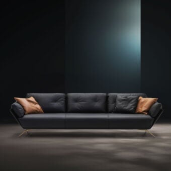 Exclusive WAYNE Enterprises WE-001 sofa with dark fabric upholstery, gold-toned metal feet and accompanying black and brown pillows