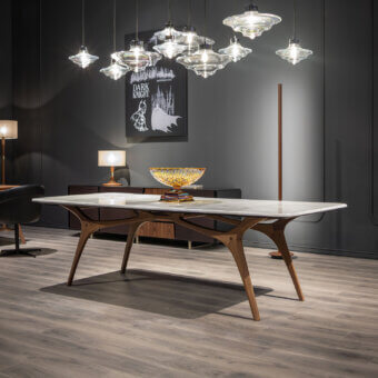 Distinguished WAYNE Enterprises WE-020 table with light marble tabletop and satin finished solid wood base exhibiting gently curved lines