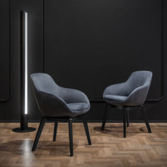 Distinguished WAYNE Enterprises WE-083 armchair with matte gray textile upholstery and dark finished wooden legs