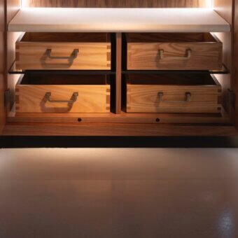 Wooden drawers within dark cabinet, light wood grain, recessed handles, LED illumination, laminate shelf, Cassoni sting inner module large.