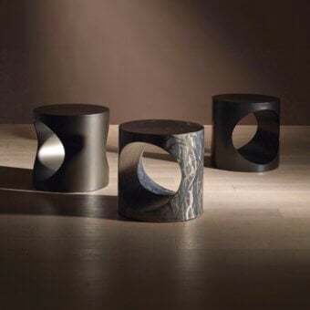 Distinguished Bellavista Hole side table with a cylindrical form and complex grey and black textured metal finish crafted in Italy