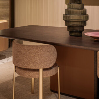 Lavish Turri Echo table crafted in Italy with walnut wood and leather, presenting a dark brown barrel-shaped top with rounded lines