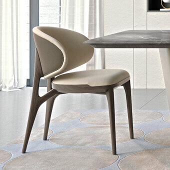 Harmonious Turri Pinnacle chair with wooden supporting structure and enveloping light beige textile upholstery with matte finish