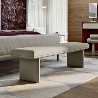 Elegant Turri Zero bench with rounded fully upholstered form in light gray synthetic material and smooth matte finish