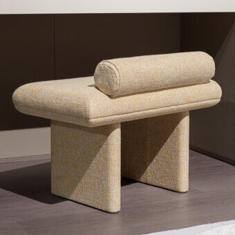 Distinctive Turri Zero ottoman with light beige textile upholstery and textured cylindrical cushion