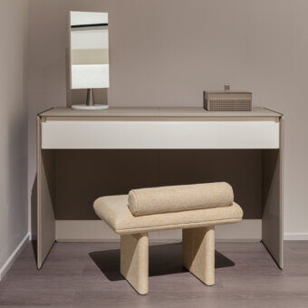 Sophisticated Turri Zero ottoman with textured light beige textile upholstery and cylindrical cushioned form