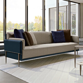 Sophisticated Turri Zero sofa with light beige textile and dark blue cushions crafted in Italian metal with a satin finish