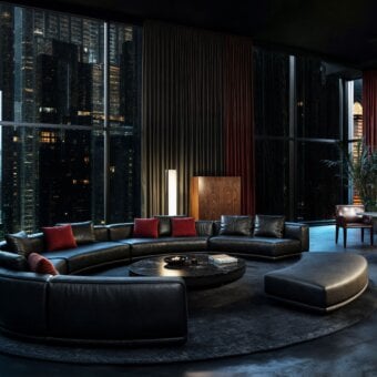 Exclusive WAYNE Enterprises WE-110 modular sofa upholstered in dark material with vibrant red cushions and lacquered base